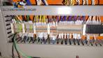 Pick and place product feeder for flowpack transfer cartoning machine