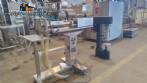 Filling machine with 2 nozzles for liquids and pilfer cap screwer