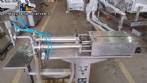 Filling machine with 2 nozzles for liquids and pilfer cap screwer