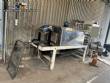 Automatic baling machine with shrink tunnel for bottles and jars in bales.