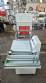 L-shaped packaging sealer with semi-automatic shrink tunnel.