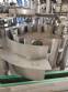 Zegla rotary filling machine with rinser and three-block capping system.