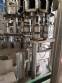 Zegla rotary filling machine with rinser and three-block capping system.